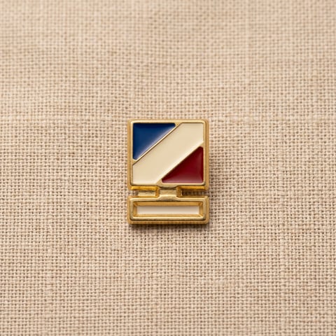 Gold enamel stripe shoe ornament on linen