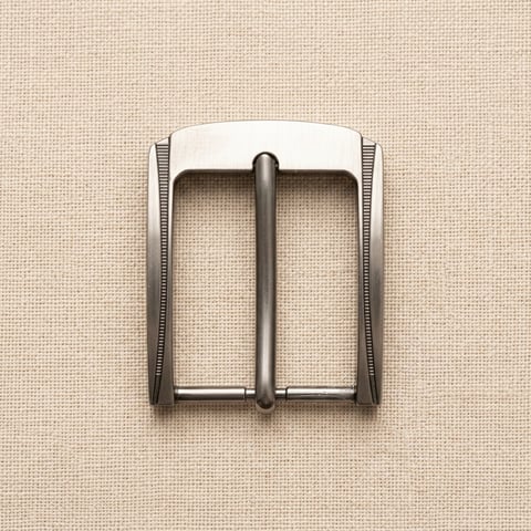 Knurled gunmetal pin belt buckle on linen