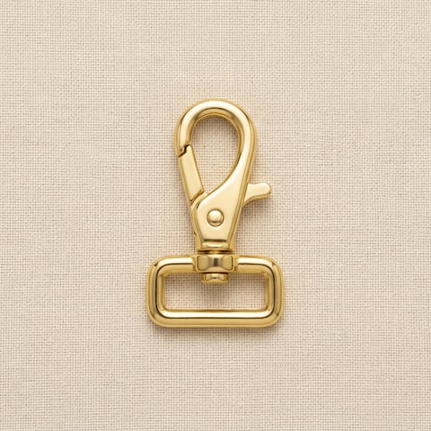 Polished brass square-loop swivel snap hook on linen