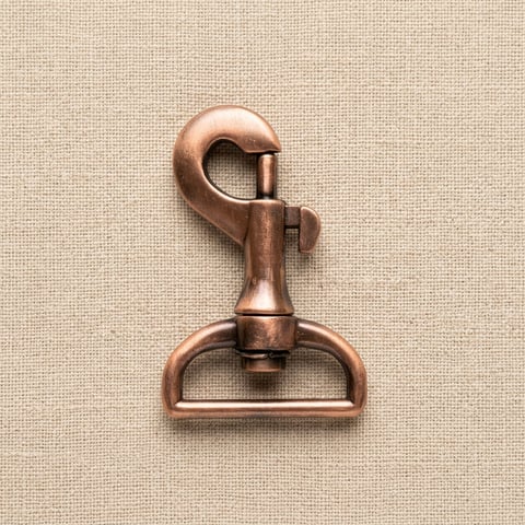 Antique copper swivel bolt snap bag fitting on linen