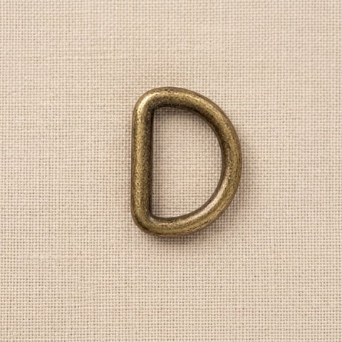 Antique brass D-ring on linen