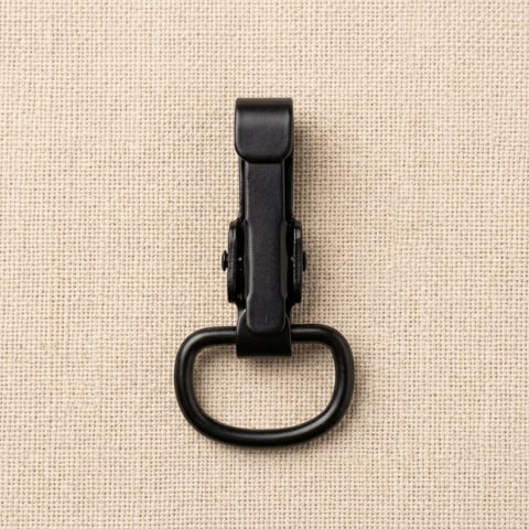 Matte black flip clasp bag fitting on linen
