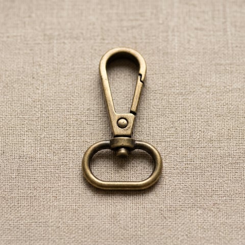 Antique brass oval loop snap hook on linen