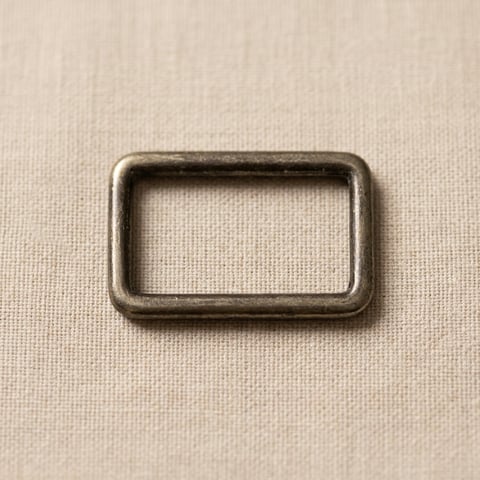 Antique finish rectangular slider ring on linen