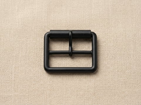 Matte black rectangular roller footwear buckle on linen