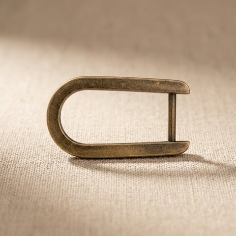 Antique brass D-shackle on linen