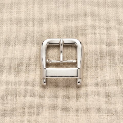 Polished silver compact roller pin footwear buckle on linen