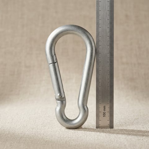 Galvanised steel spring snap carabiner on linen with measuring scale