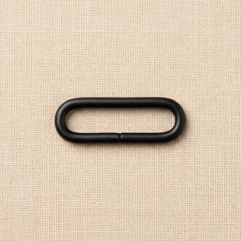 Matte black oval loop ring bag fitting on linen