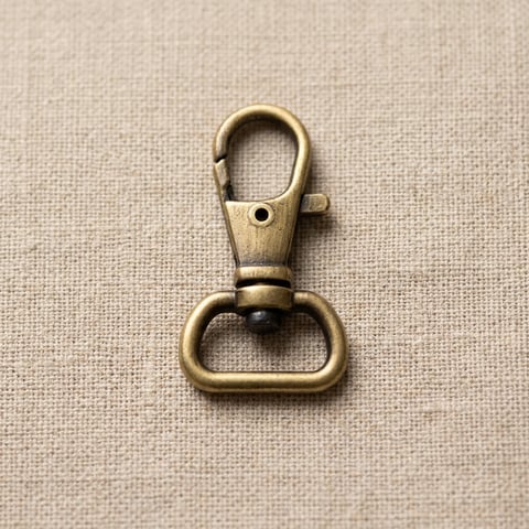 Antique brass lobster swivel snap hook on linen
