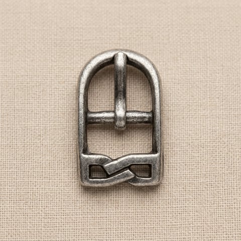 Antique silver arched footwear buckle with knot base on linen