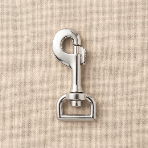 Polished nickel swivel bolt snap bag fitting on linen
