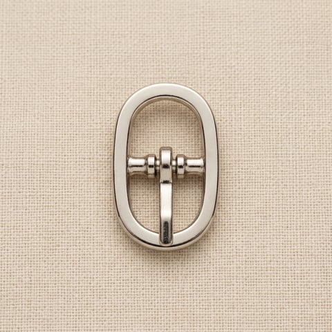 Polished nickel oval frame belt buckle on linen