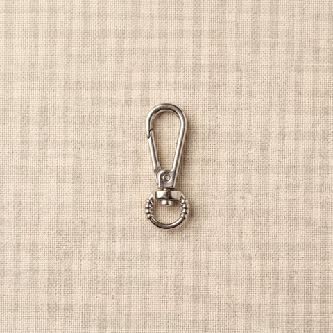 Polished silver beaded-eye swivel snap hook on linen