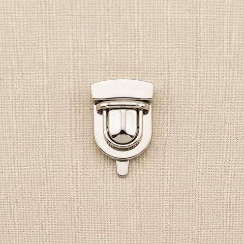 Polished nickel tuck lock bag clasp on linen
